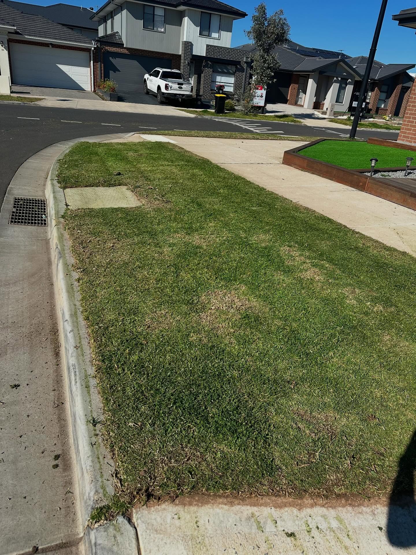 1-home-about1 Freshly mown grass nature strip with neat edges along a kerb and footpath