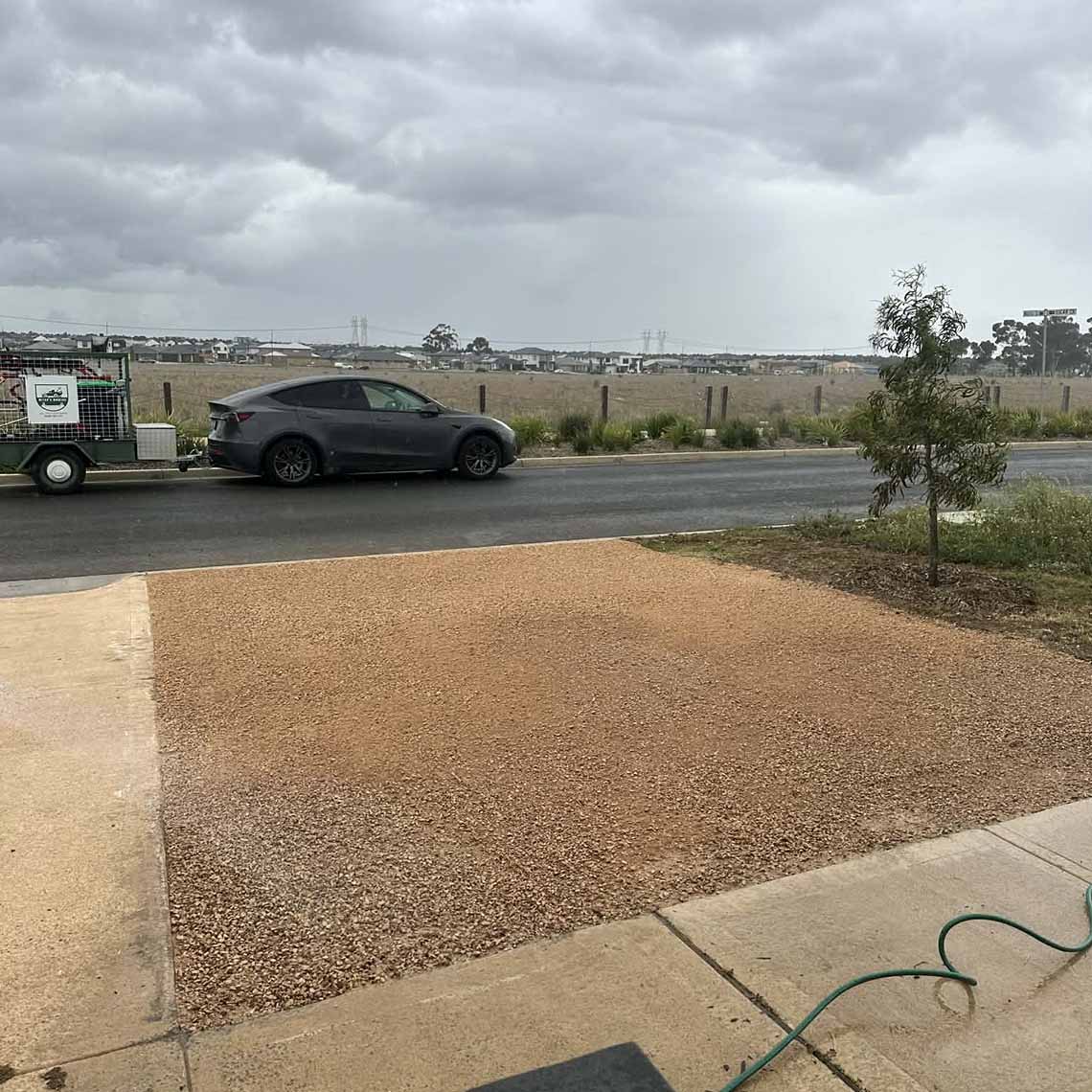 After: front yard covered in crushed rock beside the footpath