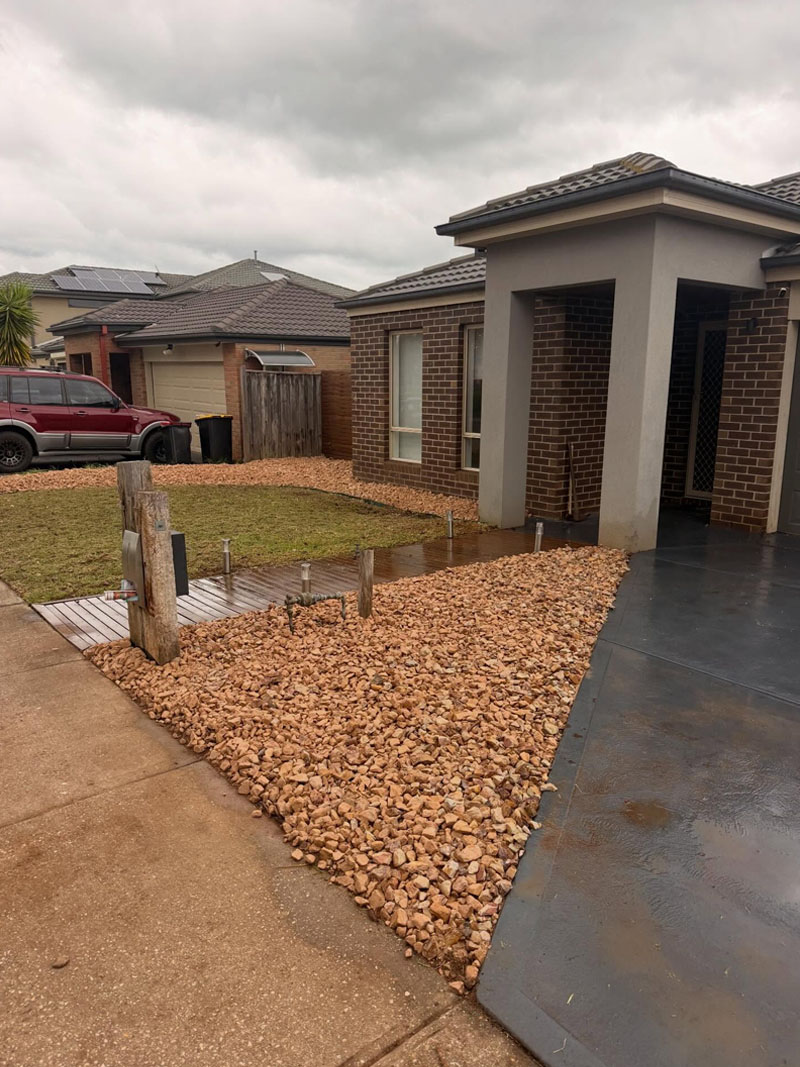 After: plants removed from the front yard and a new pebble garden bed laid
